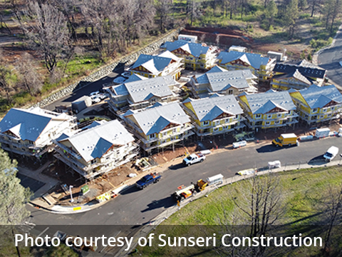 A aerial view of the construction at Paradise Community Village shows the multiple buildings have the exteriors nearly finished. The siding and roofs are being worked on.