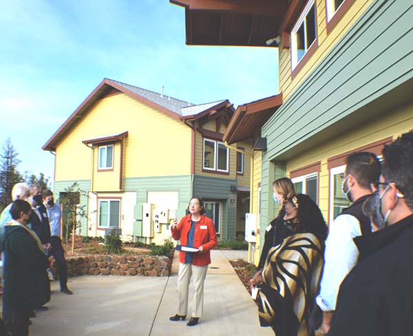 Seana O'Shaughnessy, President and CEO of CHIP, speaks in front of a group of people from North Valley Community Foundation on a tour of Paradise Community Village